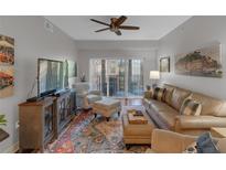 Inviting living room with plush seating, wood floors, and sliding door to balcony at 200 River Vista Dr # 436, Atlanta, GA 30339