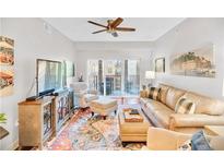 Inviting living room featuring hardwood floors and sliding glass doors to a balcony at 200 River Vista Dr # 436, Atlanta, GA 30339