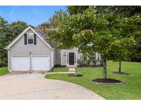Charming two-story home featuring a two-car garage, inviting front yard, and well-manicured landscaping at 3652 Arrowhead Pl, Douglasville, GA 30135
