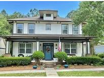 Charming two-story home with a covered front porch and landscaped front yard, perfect for relaxing outdoors at 178 Mission Oak Dr, Grayson, GA 30017