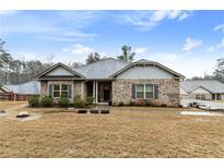 Charming single-story home with a brick facade, landscaped yard, and a welcoming covered entrance at 8268 E Carroll Rd, Whitesburg, GA 30185