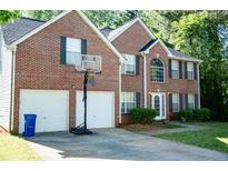 Charming two-story brick home with a well-maintained front yard and a two-car garage at 4041 Smithfield Trl, Ellenwood, GA 30294
