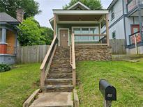 Charming home featuring a stone foundation, a welcoming porch, and a well-maintained front yard at 490 Rockwell Sw St, Atlanta, GA 30310