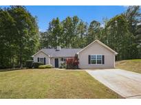 Charming single story home featuring well-maintained landscaping and a long driveway at 332 Christian Ln, Carrollton, GA 30116