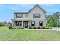 Charming two-story home boasts a beautifully landscaped front yard and welcoming curb appeal at 3985 Foxdale Ln, Cumming, GA 30028