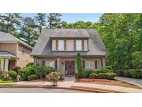 Charming two-story home features a well-manicured lawn and inviting front porch at 3800 Market Walk, Clarkston, GA 30021