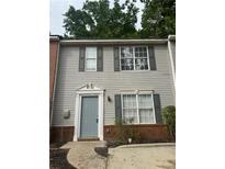 Charming two-story home with gray siding and a decorative doorframe at 5574 Fair Creek Way, Lithonia, GA 30038