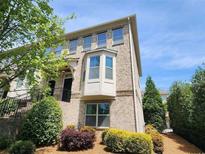 Beautiful two-story townhouse with brick exterior and manicured landscaping at 10650 Allon Cv # 137, Alpharetta, GA 30022