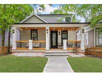 Charming home boasts a welcoming porch, manicured lawn, and craftsman details at 293 Ormond Se St, Atlanta, GA 30315