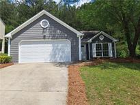 Charming single-Gathering home features a two-car garage and well-maintained lawn at 1356 Ambercrest Way, Austell, GA 30168