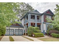 Charming two-story home with a two-car garage, inviting porch, and mature landscaping at 2604 Porchside Se Pl, Atlanta, GA 30316