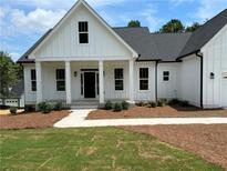 Charming home featuring a covered front porch with stately columns and fresh landscaping at 43 Wickford Way, Villa Rica, GA 30180