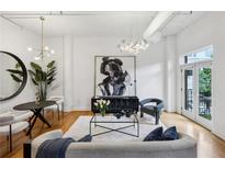Bright living room features modern lighting, hardwood floors, stylish furniture, and large abstract art at 1058 Piedmont Ave # 103, Atlanta, GA 30309