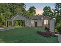 Charming one-story home featuring a side entry garage, stone accents, and lush landscaping at 507 Karen Ln, Woodstock, GA 30188