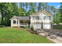 Charming two-story home with stone accents, a welcoming front porch, and a well-maintained lawn at 83 Andrew Jackson Ct, Dallas, GA 30157