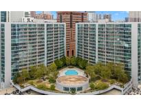 Stunning aerial view of the condo complex with pool, clubhouse, and lush landscaping, perfect for luxurious living at 44 Peachtree Ne Pl # 1929, Atlanta, GA 30309