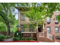 Charming townhome with brick and siding exterior, mature trees, and inviting front entrance at 655 Mead Se St # 58, Atlanta, GA 30312