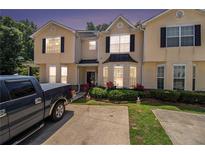 Charming townhome with beautiful curb appeal, manicured lawn, and inviting entrance, close to the neighborhood at 7324 Bridlewood Ct, Jonesboro, GA 30236