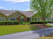 Charming single-story home featuring manicured landscaping, a brick facade, and a well-maintained lawn at 106 Vintage Club Cir, Marietta, GA 30066