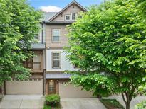 Charming townhome showcasing a well-manicured lawn, a garage, and a beautiful architectural design at 3231 Chutney Ct, Avondale Estates, GA 30002