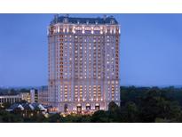 Luxury high-rise condo building featuring distinctive architectural details and stunning views at dusk at 88 W Paces Ferry # 2230, Atlanta, GA 30305