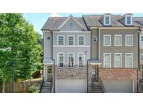 Charming townhome with gray and brick exterior, front-entry garage, and well-maintained landscaping at 2093 Callaway Nw Ct, Atlanta, GA 30318