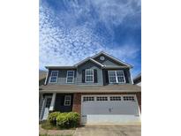 Charming two-story home with blue siding, black shutters, brick accents, and a two-car garage at 28 Samuel Nw Way, Cartersville, GA 30121