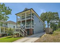 Two-story home boasting dual porches, blue siding, and a private driveway at 632 Warren Ave, Scottdale, GA 30079