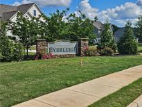 Stone sign surrounded by flowers and greenery marks the Everleigh neighborhood entrance at 125 Leveret Rd, Locust Grove, GA 30248