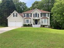 Traditional two-story home with a well-manicured lawn and inviting front entrance at 2257 Rocksram Ct, Buford, GA 30519