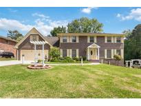 Charming two-story brick home with a well-manicured lawn and inviting curb appeal at 5152 Clearwater Dr, Stone Mountain, GA 30087