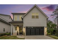 Beautiful home with an attached two-car garage, manicured lawn, and lovely front porch at 704 Fairlane Dr, Marietta, GA 30064