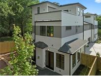 Stunning exterior elevation showcasing a modern, three-story home with white and gray siding and black-framed windows at 90 Cleveland Unit B Se St, Atlanta, GA 30316