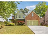 Charming two-story home with a well-manicured lawn and a three-car garage at 2853 N Thompson Ne Rd, Brookhaven, GA 30319