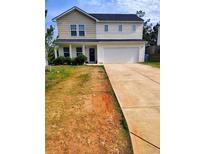 Charming two-story home with a two-car garage and a well-manicured front lawn at 713 Dove Tree Ln, Social Circle, GA 30025