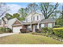 Charming two-story home with a well-manicured lawn and lovely landscaping at 2798 Glenlocke Nw Cir, Atlanta, GA 30318