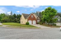 Inviting two-story home featuring a brick facade and a well-manicured lawn at 481 Jefferson Chase Se Cir, Atlanta, GA 30354