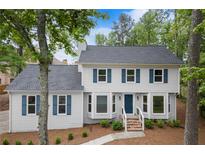 Charming two-story home featuring blue shutters and a well-maintained front yard at 3070 Branford Ct, Marietta, GA 30062