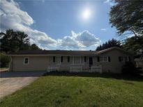Charming single-story home with a sunny front yard and attached garage at 237 Sandra Nw Dr, Lilburn, GA 30047