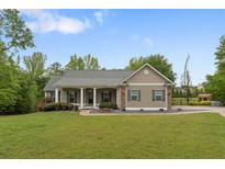 Charming single-story home with a covered front porch and well-manicured lawn at 109 J O Simmons Path, Douglasville, GA 30134
