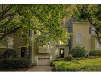 Charming two-story townhouse with lush landscaping, a one-car garage, and inviting curb appeal for comfortable living at 27 Sycamore Sta, Decatur, GA 30030