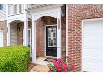 Inviting brick townhome entrance with a covered porch and well-manicured landscaping at 2826 Snapfinger Mnr, Decatur, GA 30035
