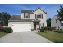 Charming two-story home with a two car garage and well-manicured front lawn at 6069 Semaphore Rdg, Rex, GA 30273