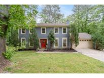 Charming two-story home with a well-manicured lawn and a vibrant red front door at 2910 Edwards Ct, Marietta, GA 30068