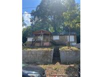 Charming single-story home with front porch amid lush greenery, offering a serene and private setting at 2066 Bethel Nw Dr, Atlanta, GA 30314