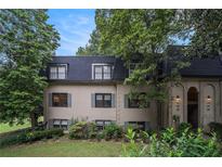 Charming two-story home with lush landscaping, shuttered windows, and an arched entrance at 170 Elysian Nw Way, Atlanta, GA 30327