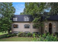 Charming townhome with a manicured lawn and mature trees provides natural shade and curb appeal at 170 Elysian Nw Way, Atlanta, GA 30327