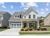 Charming two-story home with a welcoming front porch and beautifully landscaped front yard at 4207 N Carver Dr, Atlanta, GA 30360