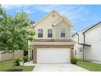 Charming home featuring a two-car garage and traditional architectural details at 6454 Grey Fox Way, Riverdale, GA 30296