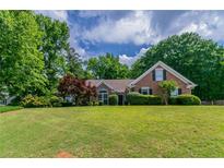 Charming single-story home with a well-manicured lawn and lush, mature trees at 2950 Camary Place Se Dr, Conyers, GA 30094